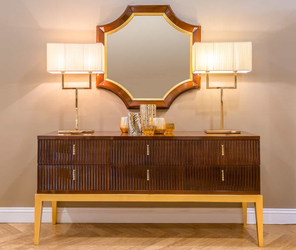 Living room with a mirrored console cabinet and lamps, illustrating mirrored furniture as a decor idea