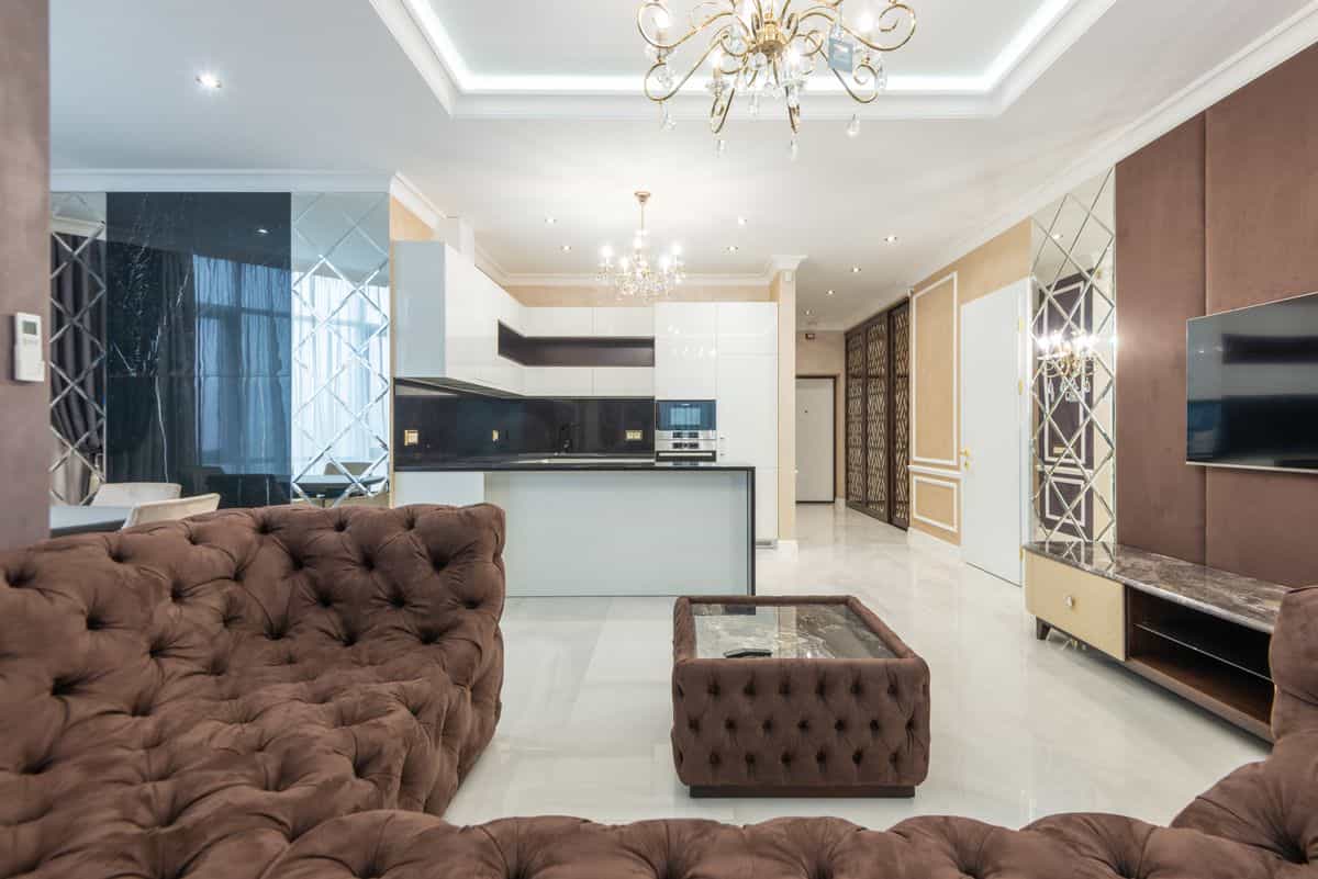 Plush living room illustrating how to keep a mirrored accent wall elegant rather than stark Plush modern living room with elegant lighting, illustrating how to style a mirror accent wall elegantly