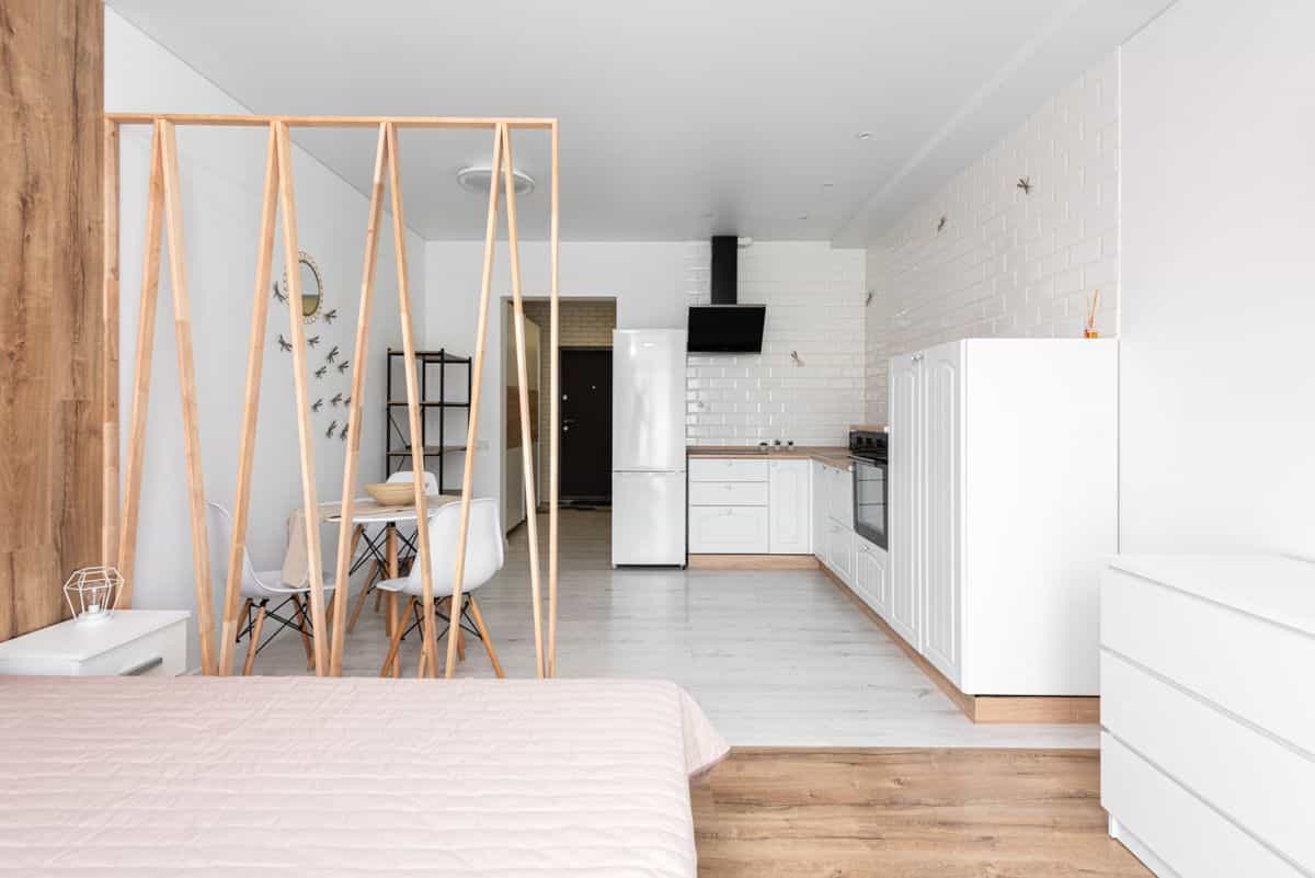 Bright modern studio apartment with an open kitchen and minimalist decor, illustrating feng shui in a small space.