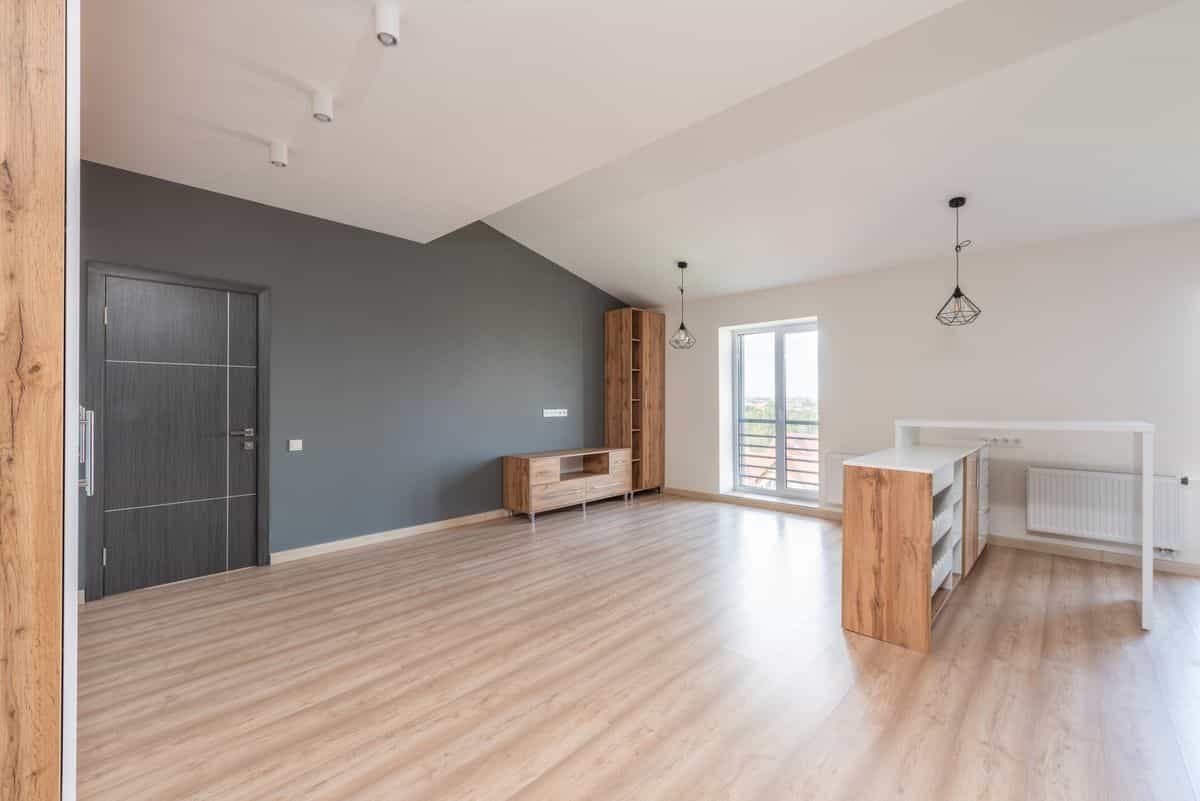 Living room with a gray accent wall illustrating how to choose the right accent wall Contemporary living room with a gray accent wall and natural light, illustrating how to choose a living room accent wall