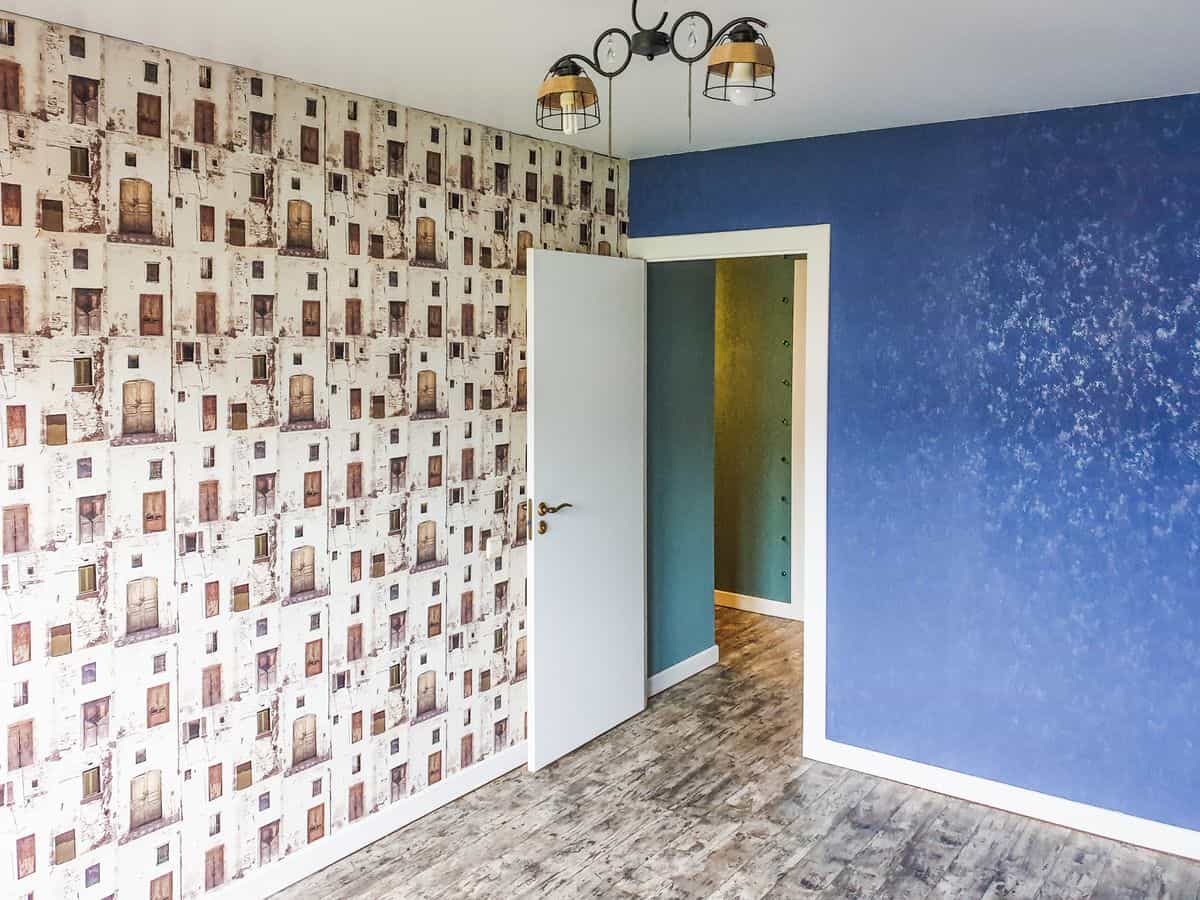 Living room with a patterned wallpaper accent wall illustrating wallpaper accent wall ideas Modern living space with a blue patterned wallpaper feature wall, illustrating wallpaper as living room accent wall decor